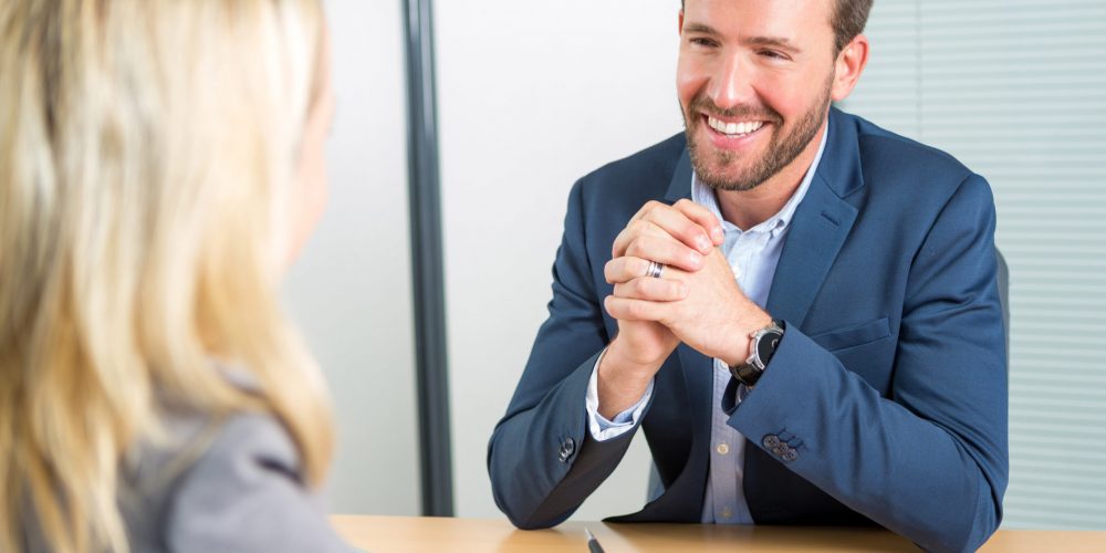 Young attractive employer doing a job interview to a woman View of a Young attractive employer doing a job interview to a woman