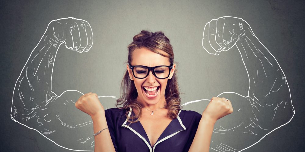 happy woman exults pumping fists celebrates success on gray wall background happy woman exults pumping fists celebrates success on gray wall background